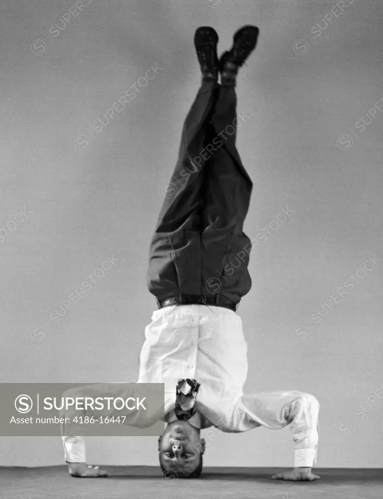 1950S Man In Shirt And Tie Standing On Head