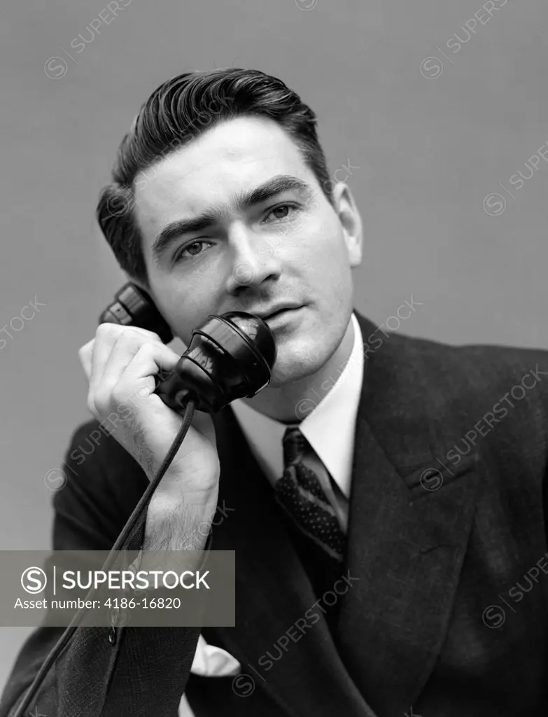 1930S Portrait Serious Man In Dark Suit Talking On Telephone