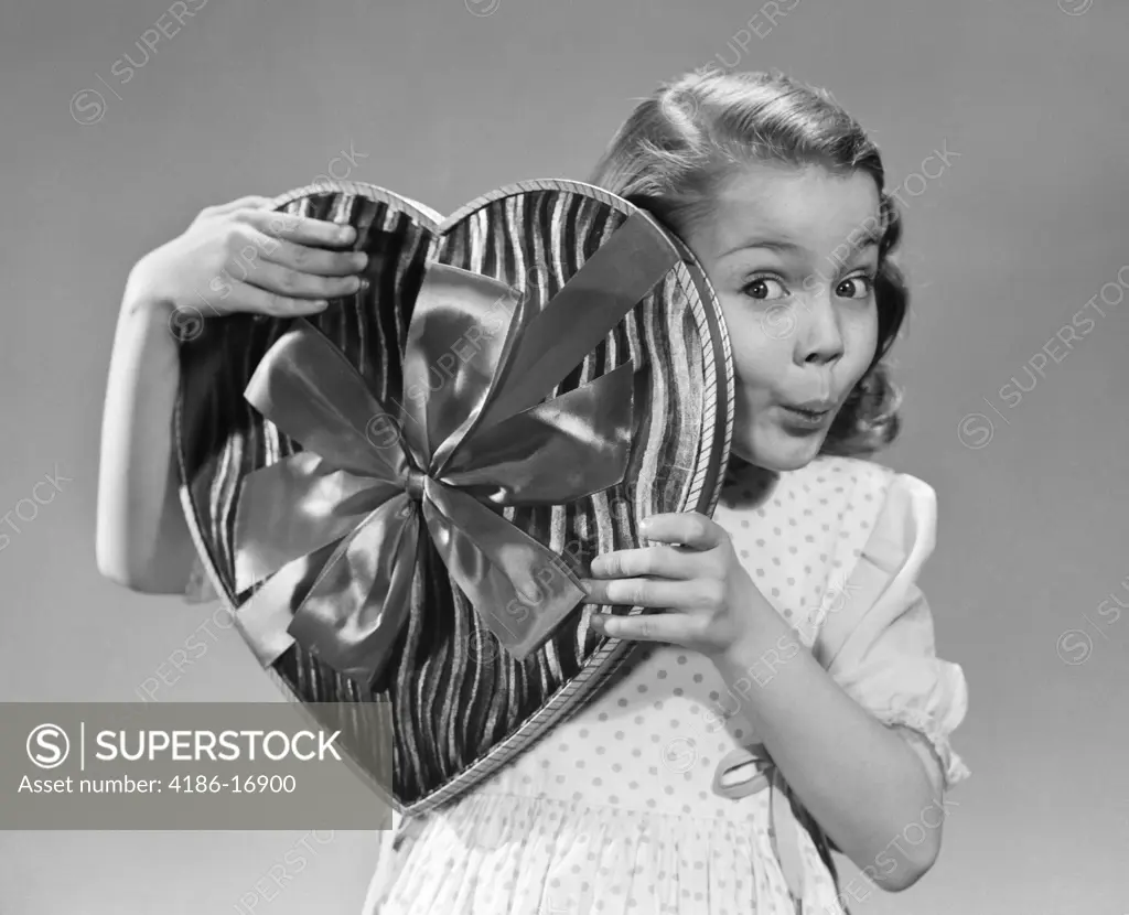 1950S Surprised Little Girl Peeking From Behind Big Heart Shaped Box Of Valentine Candy