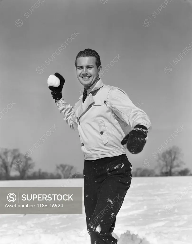 1930S Smiling Man Playing Outside About To Throw Snowball