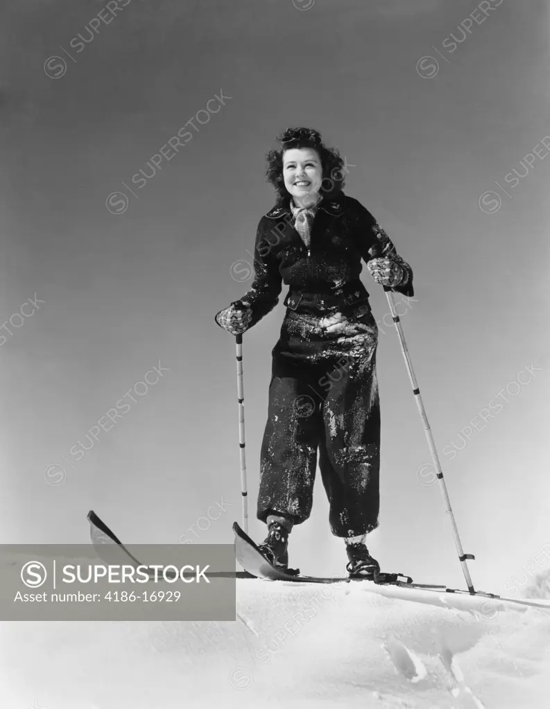 1930S 1940S Woman Smiling Standing On Wood Skis On Snow Holding Bamboo Ski Poles