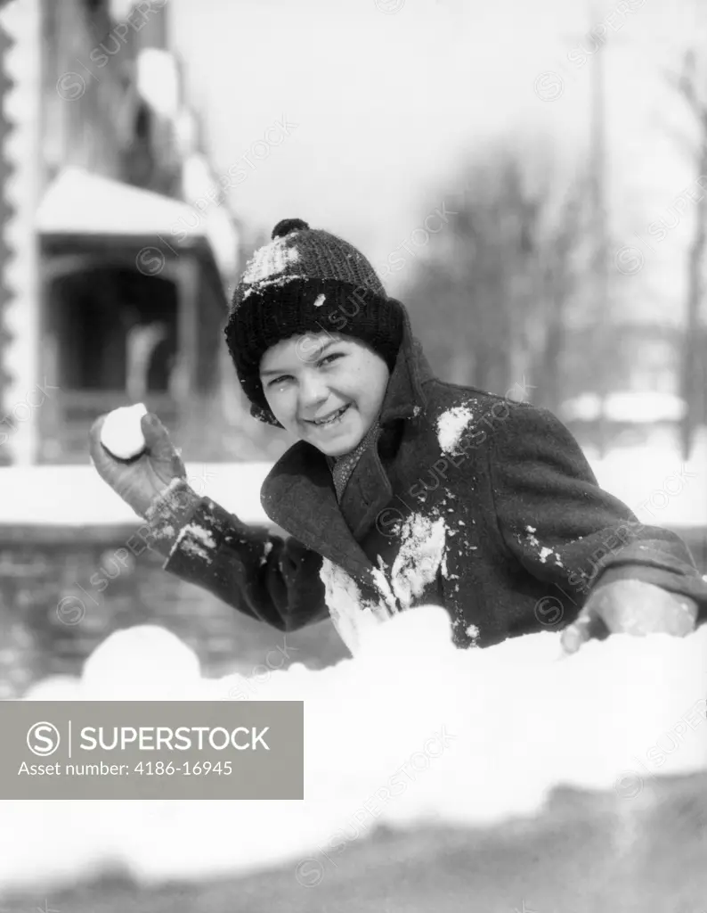 1920S 1930S Smiling Boy About To Throw Toss Snowball Playing Snow Fun Winter Cold Mischief