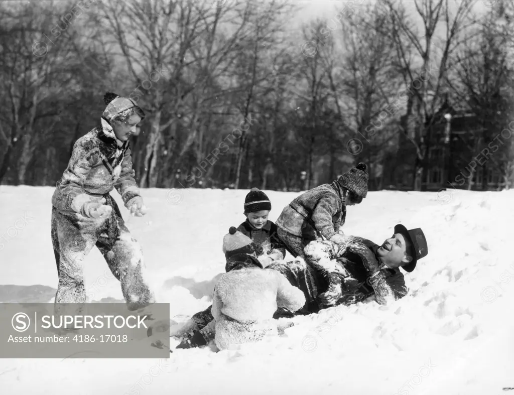 1930S Father And Mother With 3 Kids Dressed In Winter Clothing Playing In Snow Field