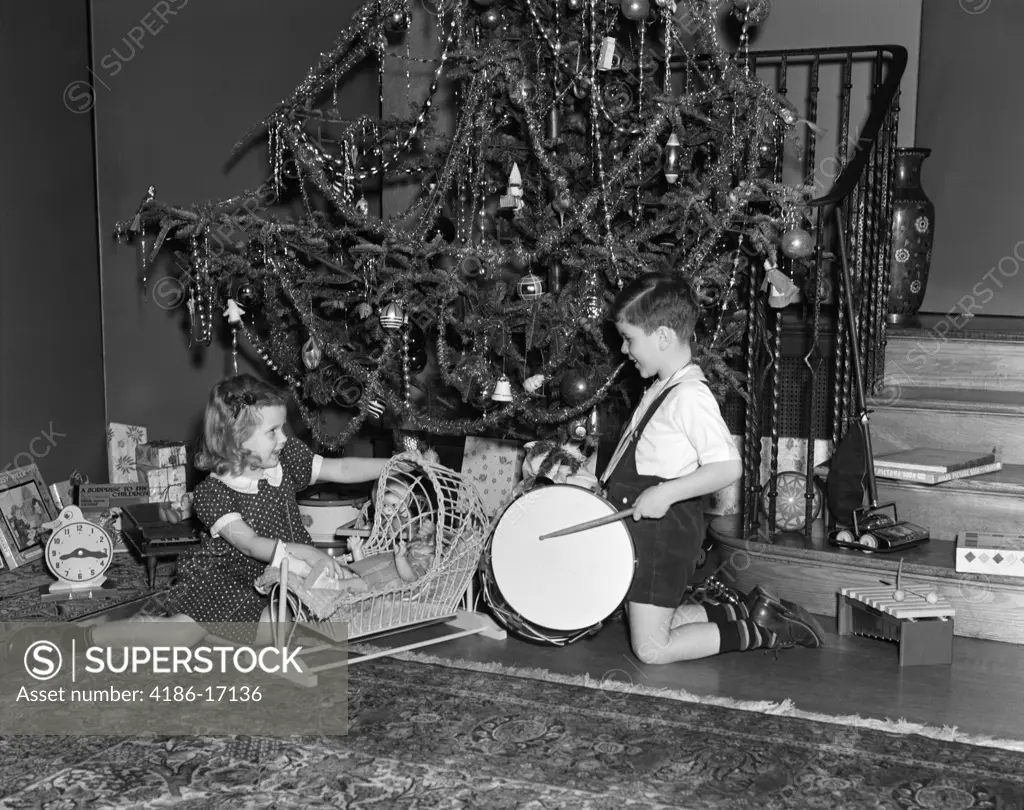 1930S Boy And Girl Playing With Presents By Christmas Tree