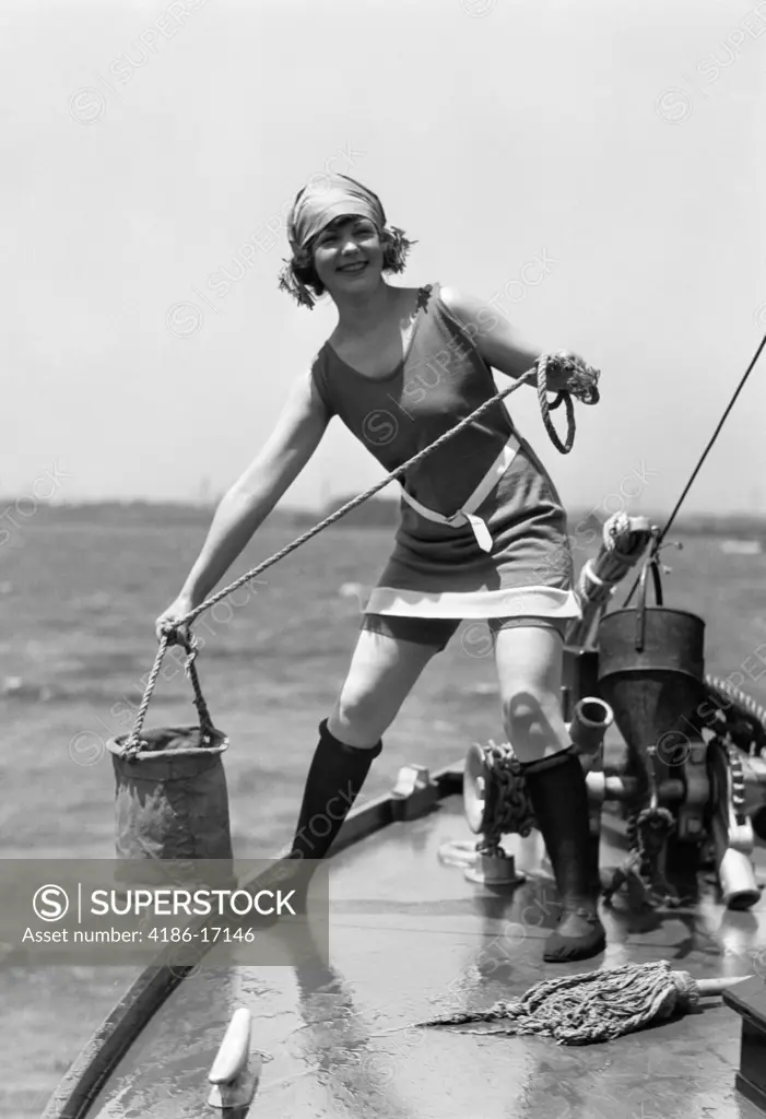 1920S Woman In Bathing Suit Pulling Bucket Of Water Aboard A Boat Outdoor