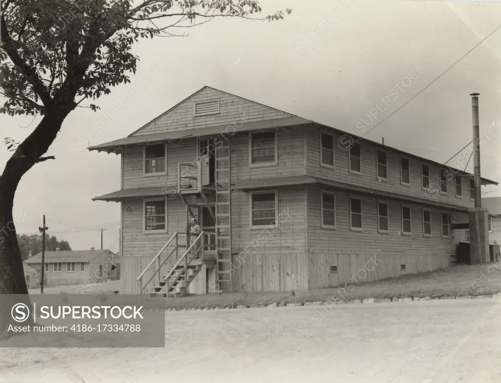 1940s EXTERIOR OF TYPICAL WORLD WAR 2 ERA UNITED STATES MILITARY ARMY UNIVERSAL WOODEN TWO STORY BARRACKS BUILDING 