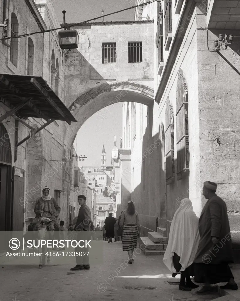 1950s CENTRAL ECCE HOMO ARCH ON VIA DOLOROSA STATION OF THE CROSS STREET SCENE OLD JERUSALEM