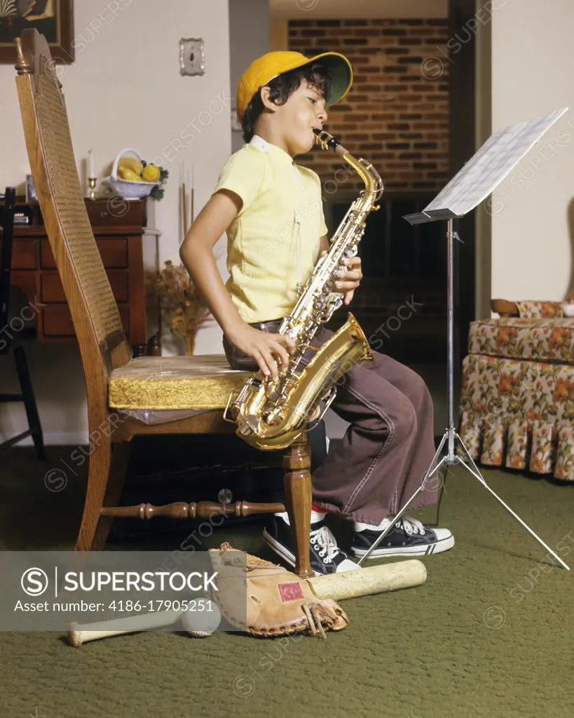 1960s 1970s BOY PRACTICING PLAYING SAX SAXOPHONE BASEBALL CAP BAT BALL GLOVE AT FEET