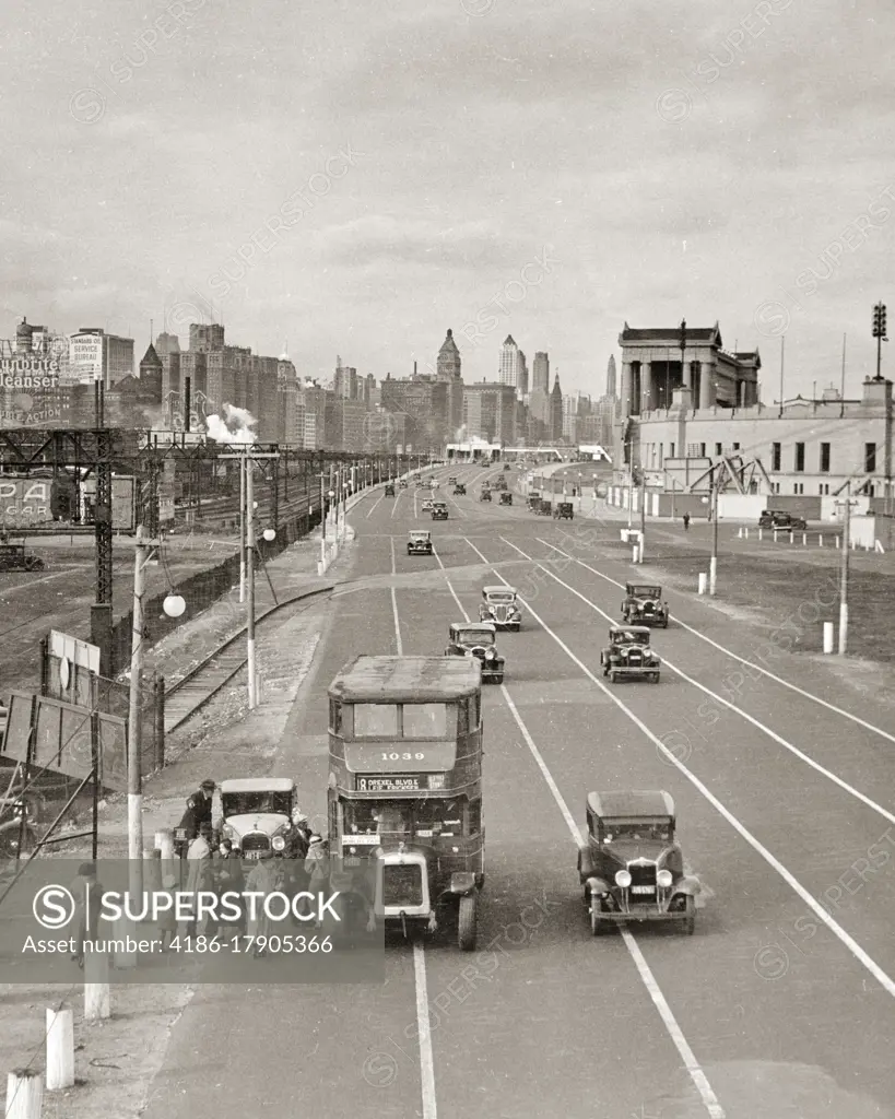 1930s VISITORS WAITING FOR BUS TO 1933 WORLDS FAIR A CENTURY OF PROGRESS EXPOSITION NEAR SOLDIER FIELD IN CHICAGO IL USA