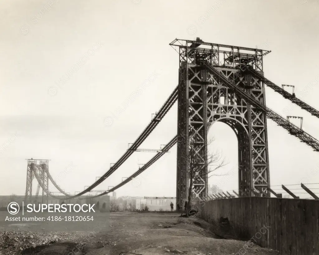 1920s 1930s VIEW OF GEORGE WASHINGTON SUSPENSION BRIDGE WHILE UNDER CONSTRUCTION FROM NJ TO NEW YORK TWO TOWERS BUT NO ROADWAY