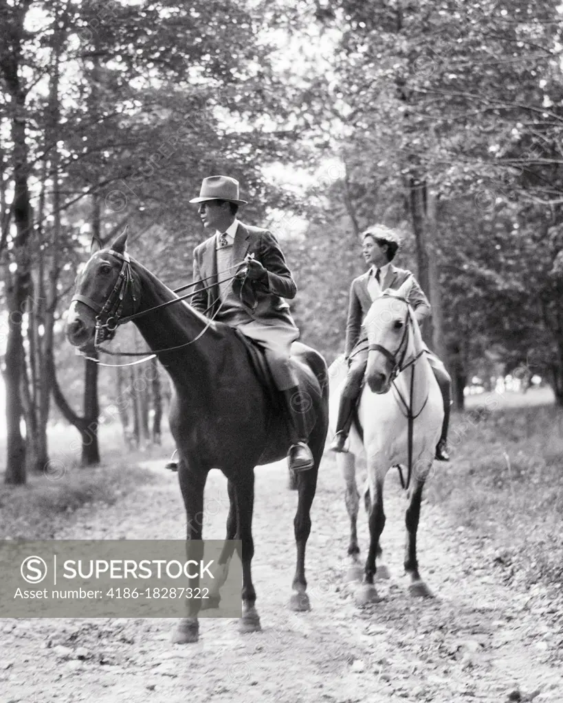 1920s 1930s COUPLE RIDING HORSES IN WOODS IN THE BERKSHIRES NEAR PITTSFIELD MA USA