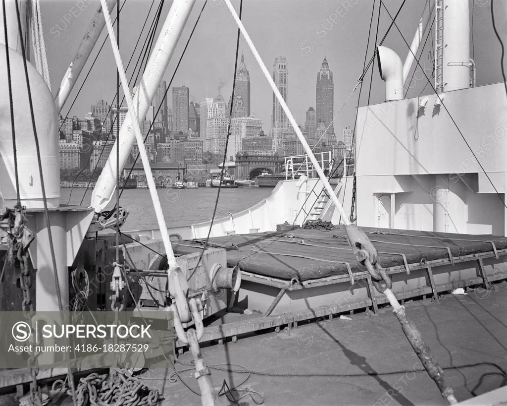 1940s DOWNTOWN SKYSCRAPER BUILDING SKYLINE FROM DECK OF FREIGHTER NAVIGATING HUDSON RIVER NEW YORK CITY NEW YORK USA