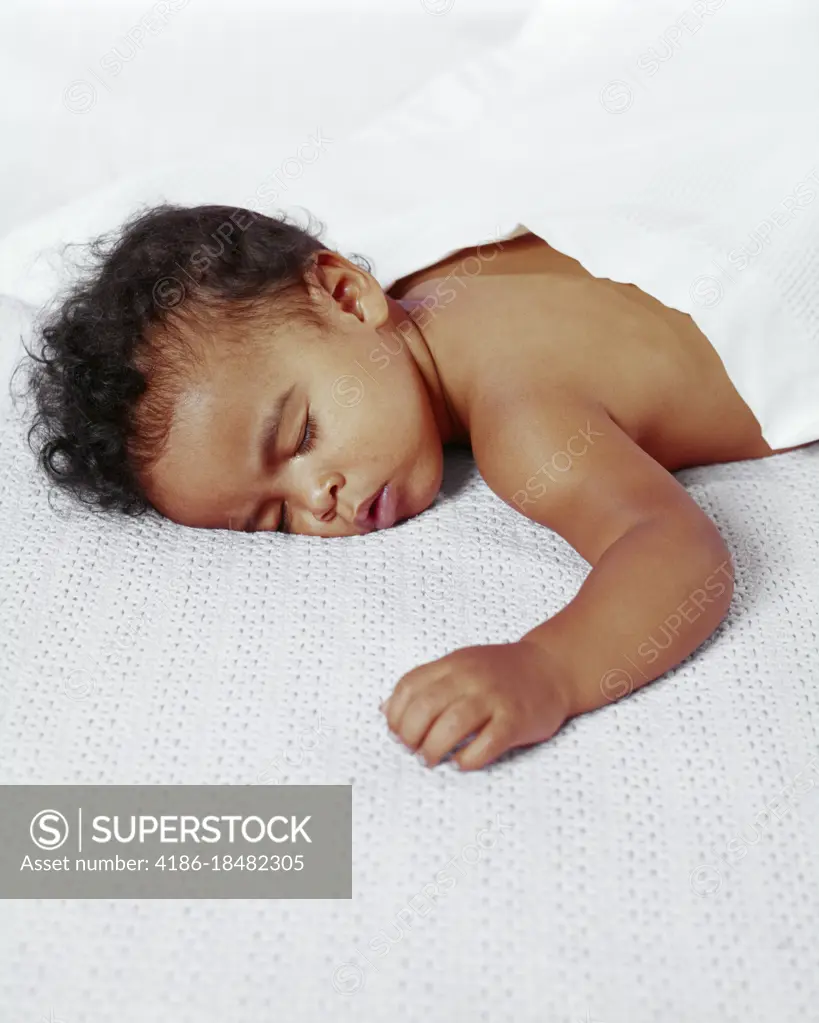 1970s AFRICAN-AMERICAN BABY BOY SLEEPING ON HIS STOMACH