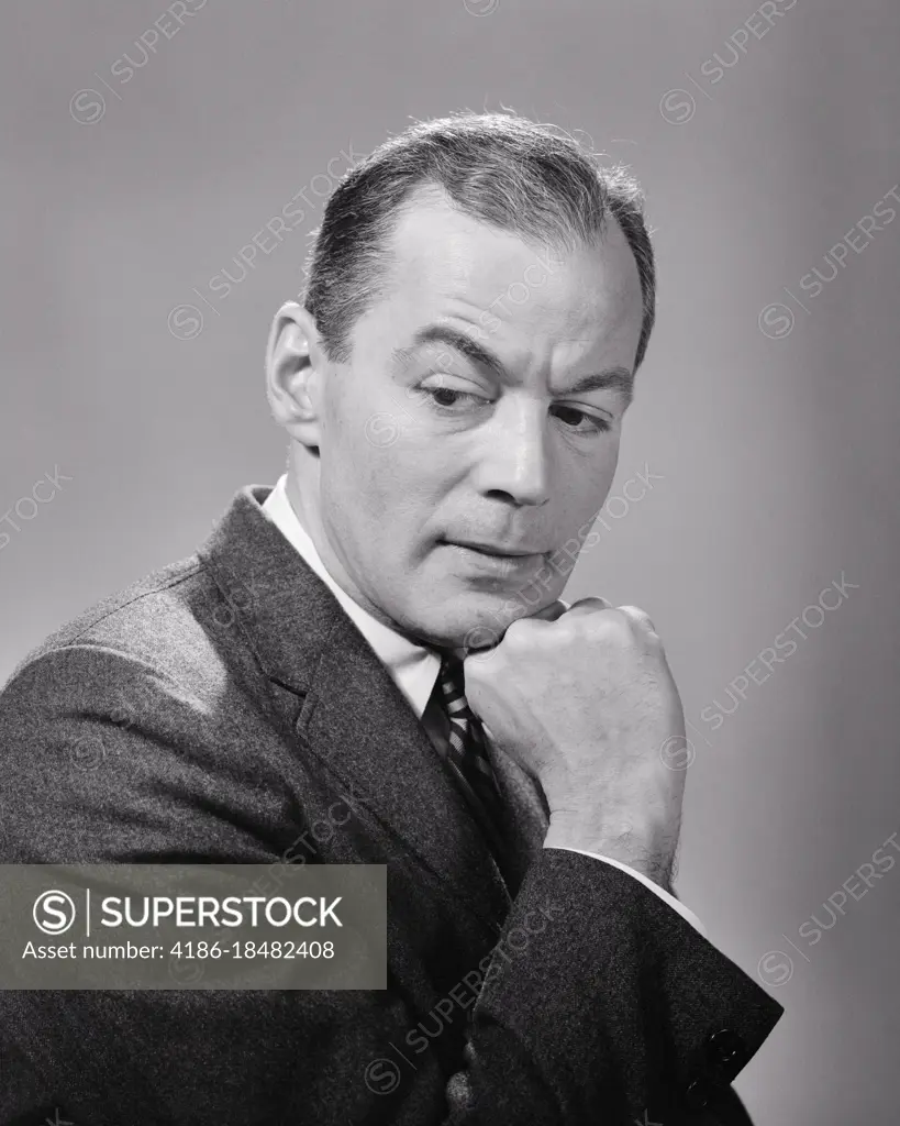 1950s 1960s BUSINESS MAN SERIOUS FACIAL EXPRESSION CHIN RESTING ON HAND THINKING CONCERNED WORRIED HAVING SECOND THOUGHTS 