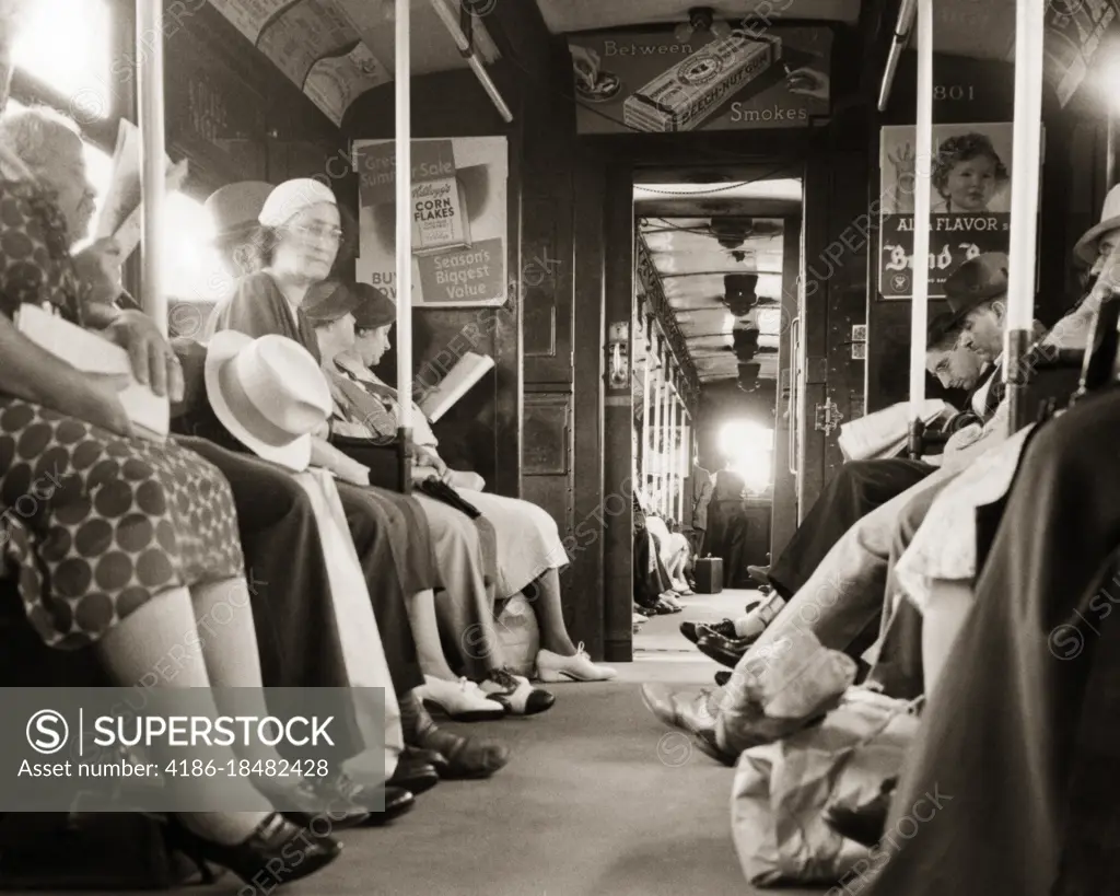 1930s INTERIOR OF HUDSON AND MANHATTAN SUBWAY TRAIN CAR WITH ANONYMOUS COMMUTERS GOING FROM JERSEY CITY NJ TO MANHATTAN NYC USA