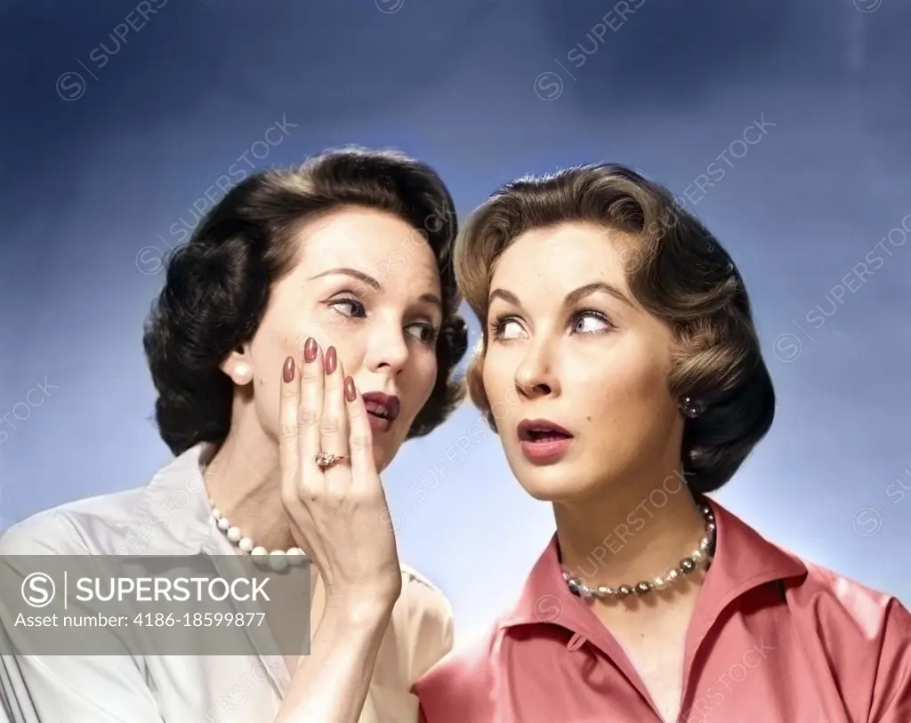 1950s 1960s TWO NOSEY WOMEN GOSSIPING ONE WHISPERING INTO THE OTHER'S EAR