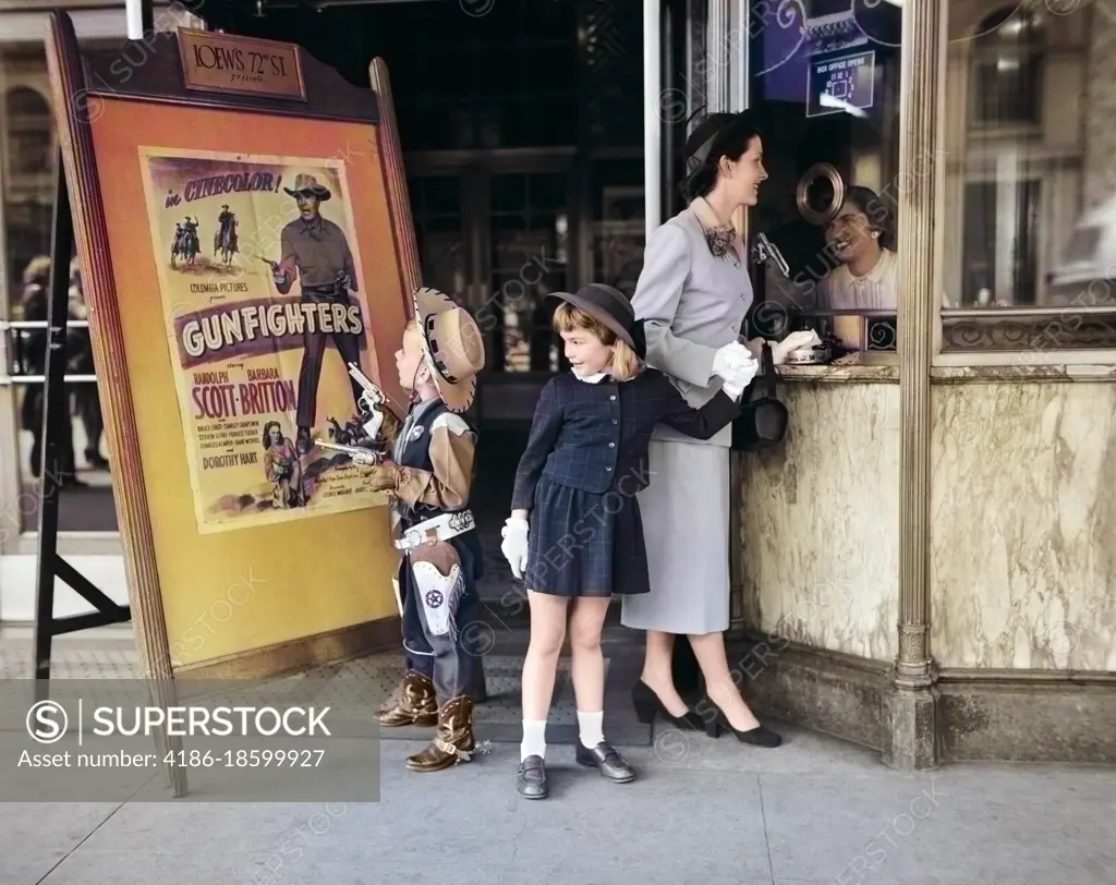 1950s MOTHER 2 CHILDREN BUYING TICKETS TO MOVIE MATINEE BOY WEARING COWBOY COSTUME