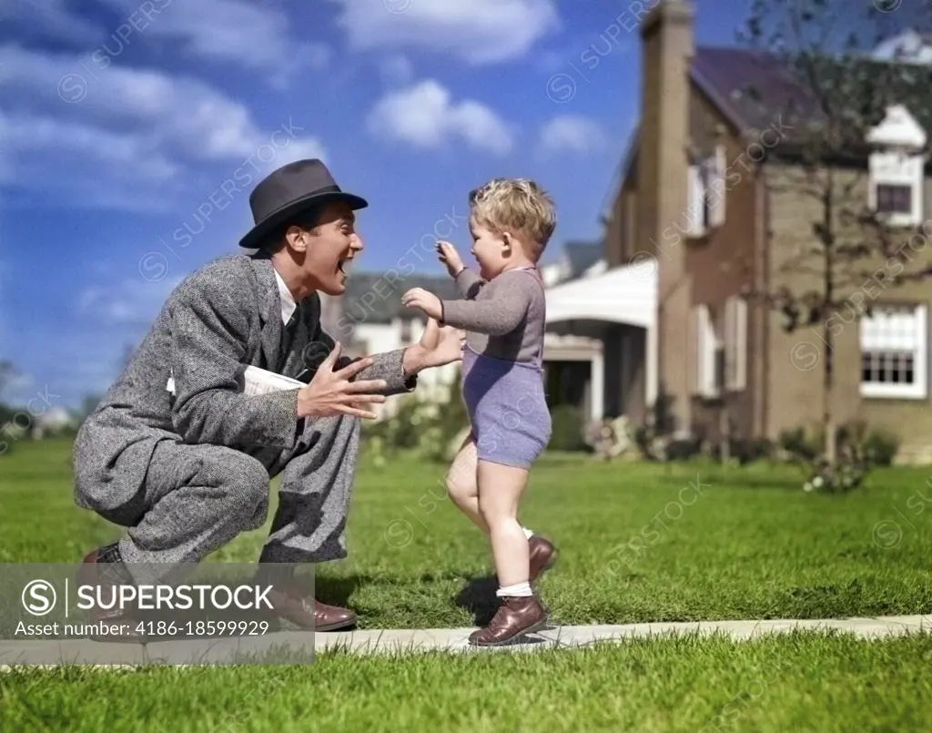 1940s FATHER GREETING SON RUNNING TOWARDS HIM ON SIDEWALK