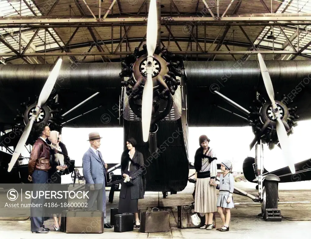 1920s 1930s GROUP OF PASSENGERS WAITING IN FRONT OF FORD TRI-MOTOR AIRPLANE