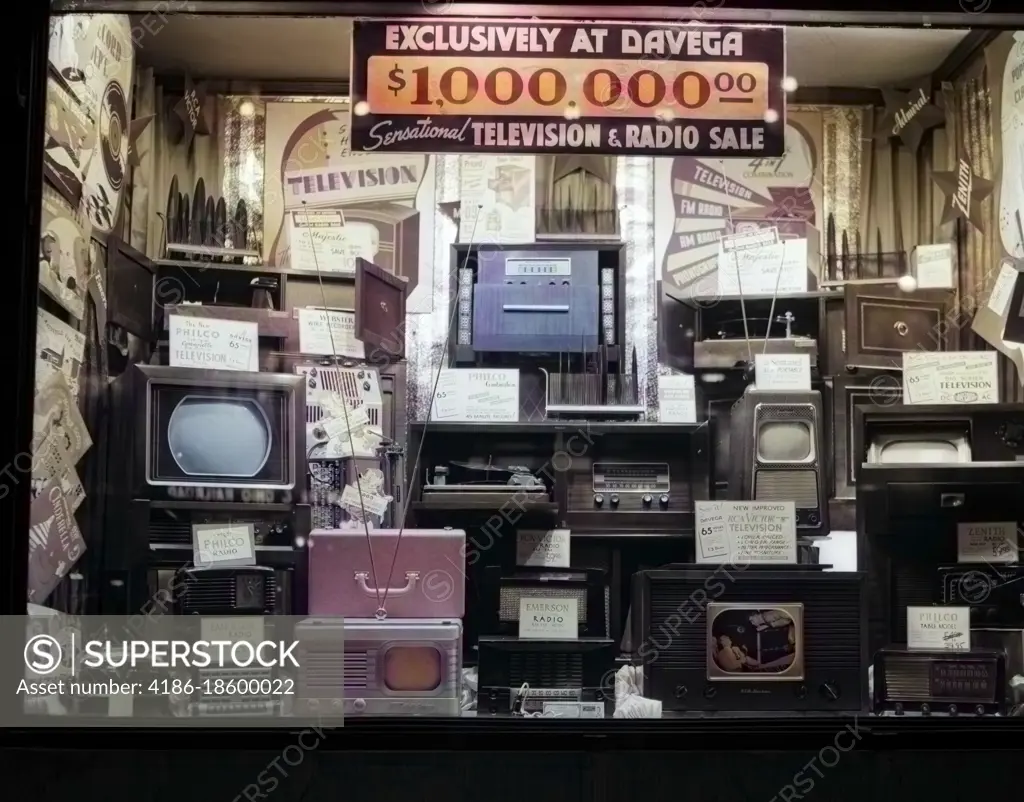 1940s WINDOW OF STORE SELLING RADIOS AND TELEVISIONS ADVERTISING A MILLION DOLLAR SALE