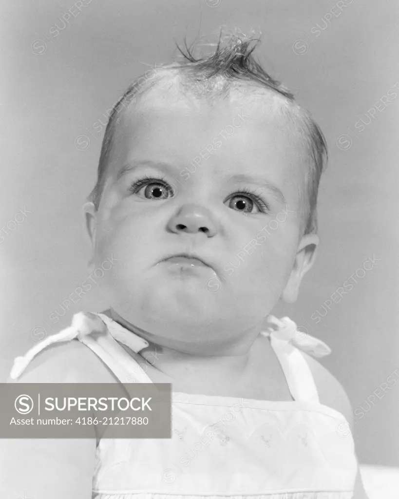 1950s 1960s PORTRAIT BABY ANGRY MAD MEAN BELLIGERENT FACIAL EXPRESSION LOOKING AT CAMERA