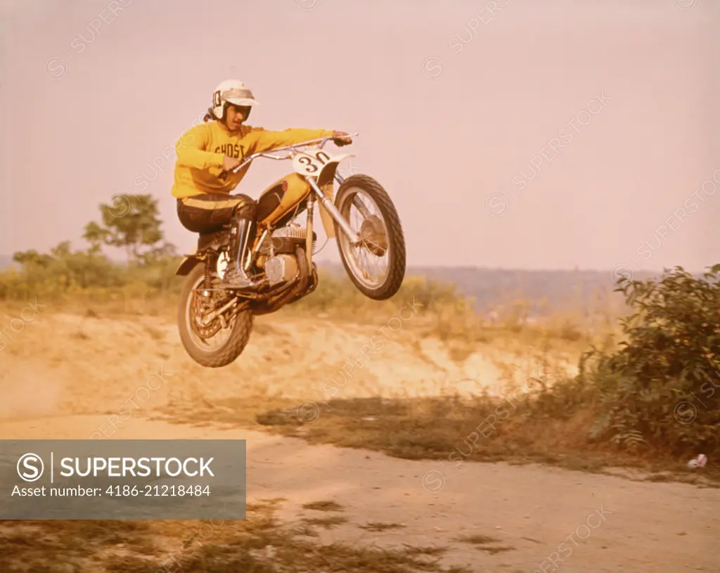 1970s MOTORCYCLE CROSS COUNTRY RACE MAN ON BIKE NUMBER 30 JUMPING IN AIR