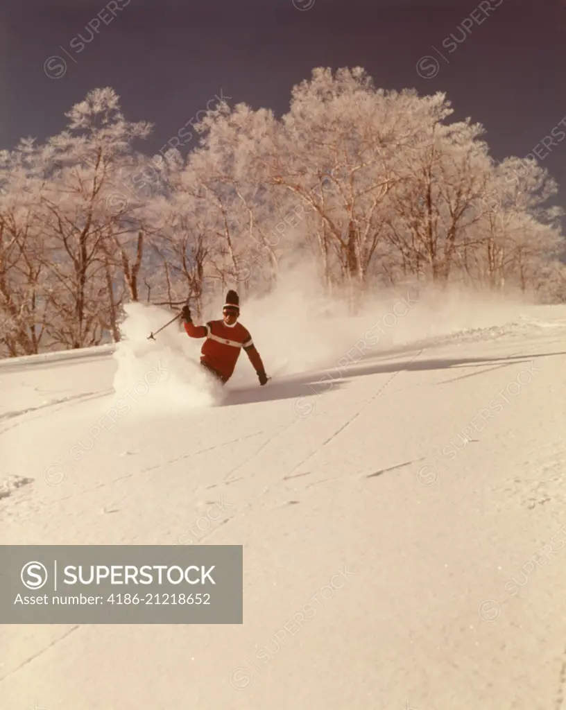 1960s 1970s MAN SKIER SHUSHING DOWN SLOPE KICKING UP SPRAY OF POWDER SNOW WEARING RED SWEATER