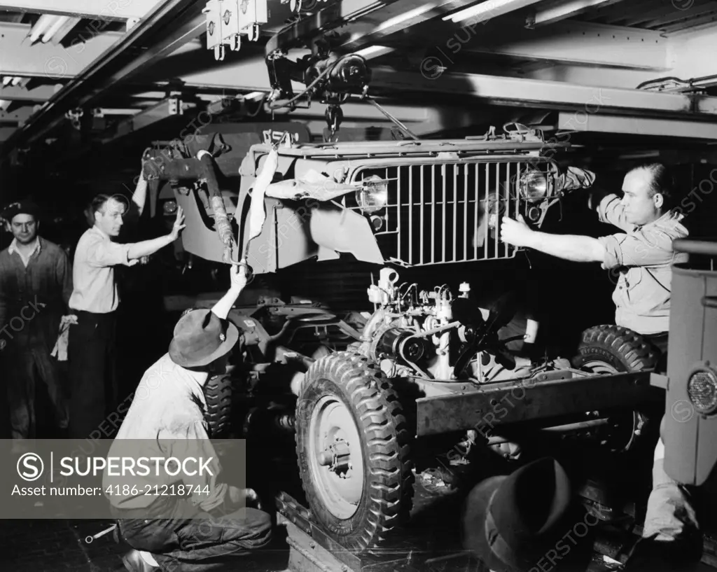 1940s DEFENSE WORKERS AUTOMOBILE ASSEMBLY LINE DROP BODY ONTO CHASSIS BLITZ BUGGY JEEP FORD RIVER ROUGE PLANT DETROIT MI USA