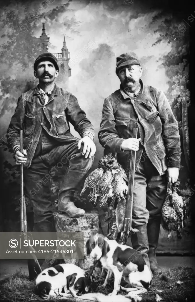 1890s TWO MEN HUNTERS LOOKING AT CAMERA POSED WITH BRACE OF BIRDS DOGS AND SHOTGUNS TURN OF THE 120TH CENTURY