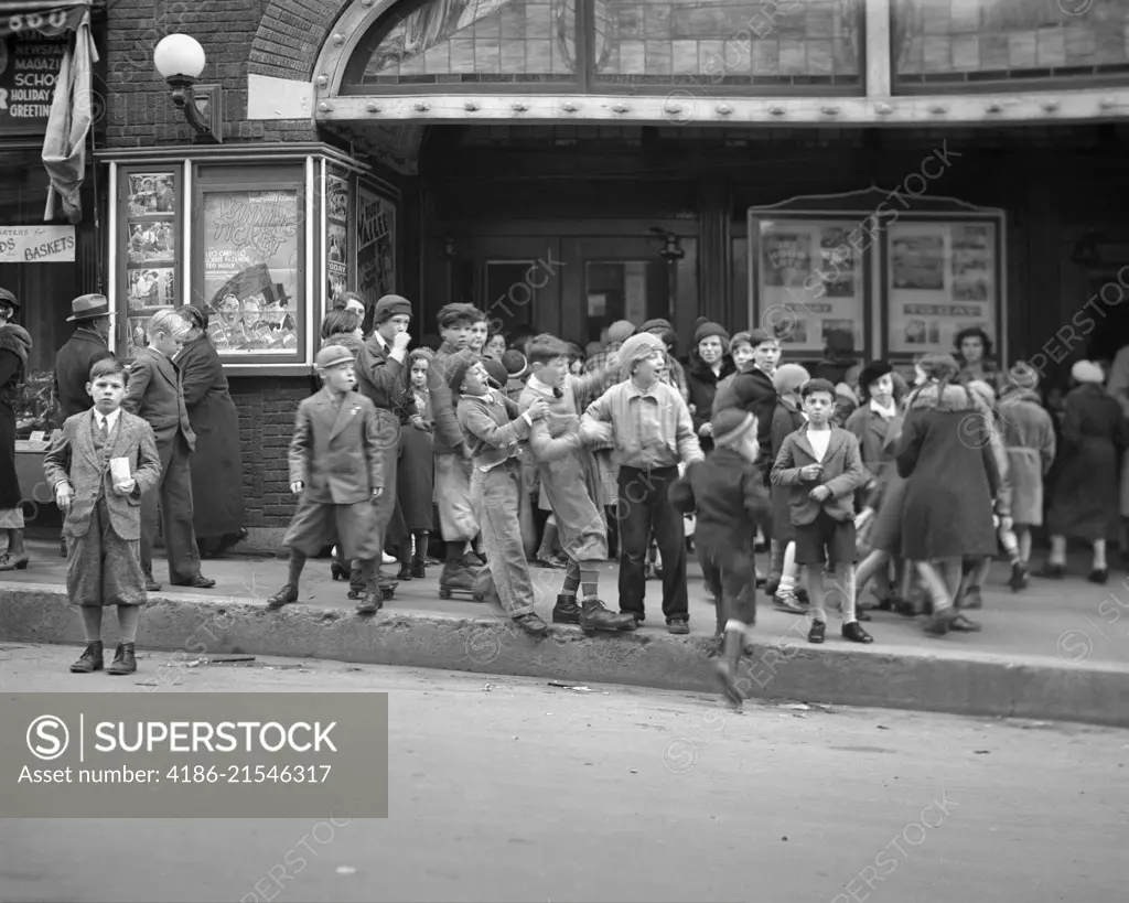 1920s 1930s NEIGHBORHOOD BOYS AND GIRLS WAITING TO GET INTO A MOVIE MATINEE IN WATERBURY CONNECTICUT USA