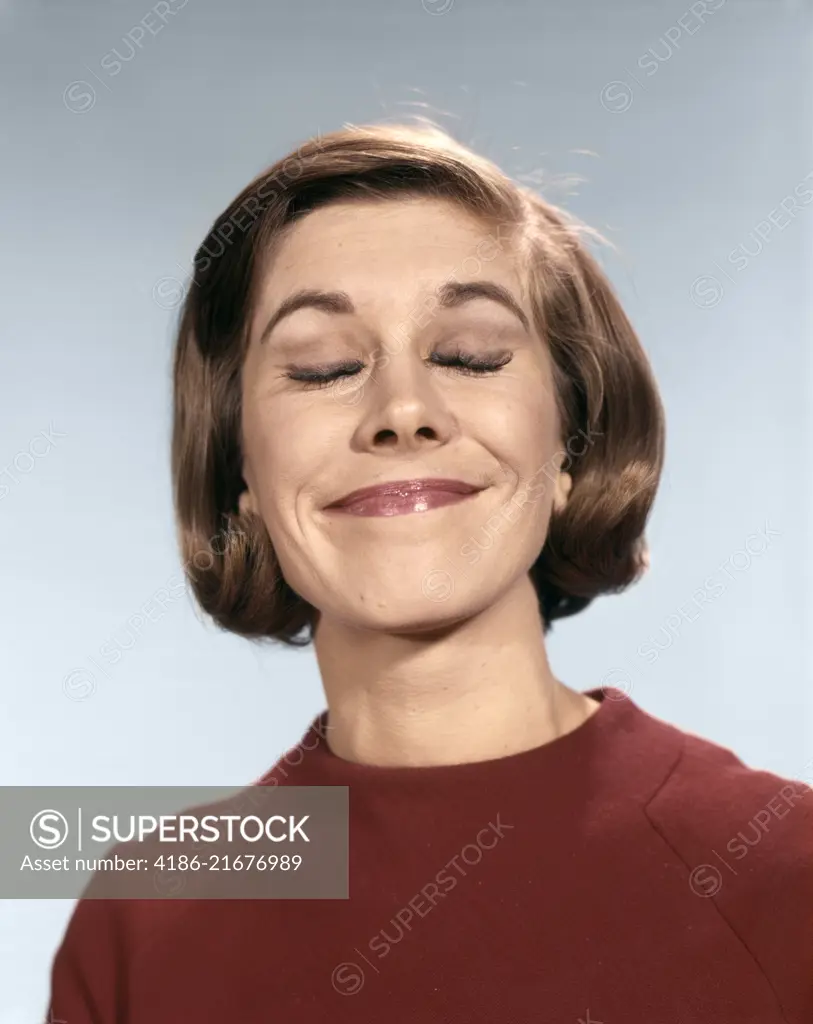 1960s PORTRAIT OF YOUNG WOMAN IN SWEATER WITH SMUG SMILE PLEASED AND HAPPY EXPRESSION