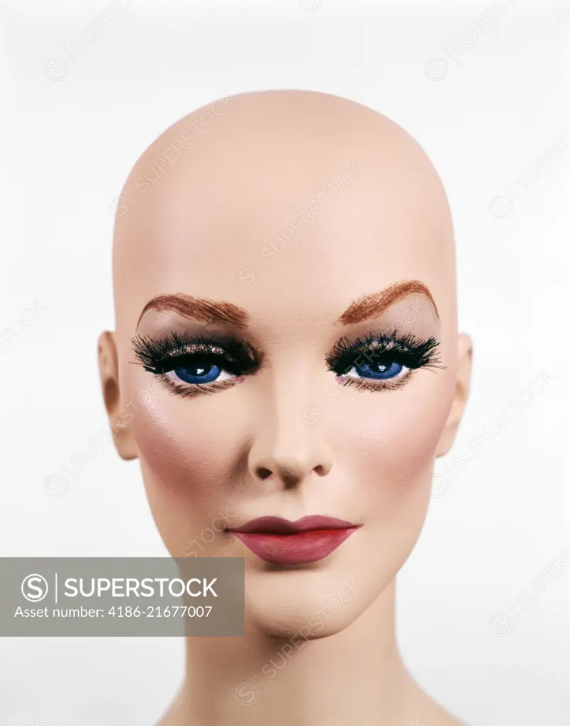 BALD HEAD OF FEMALE MANNEQUIN DUMMY LOOKING AT CAMERA 