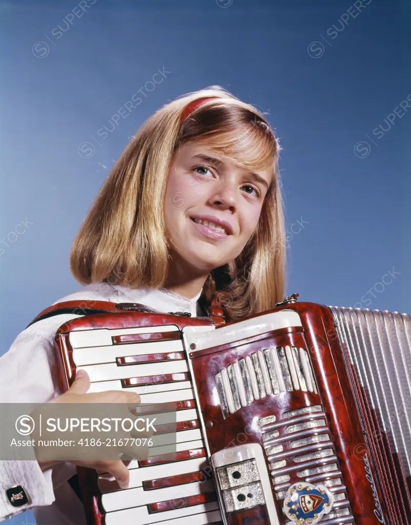 1960s 1970s TEENAGE GIRL SMILING PLAYING ACCORDION 