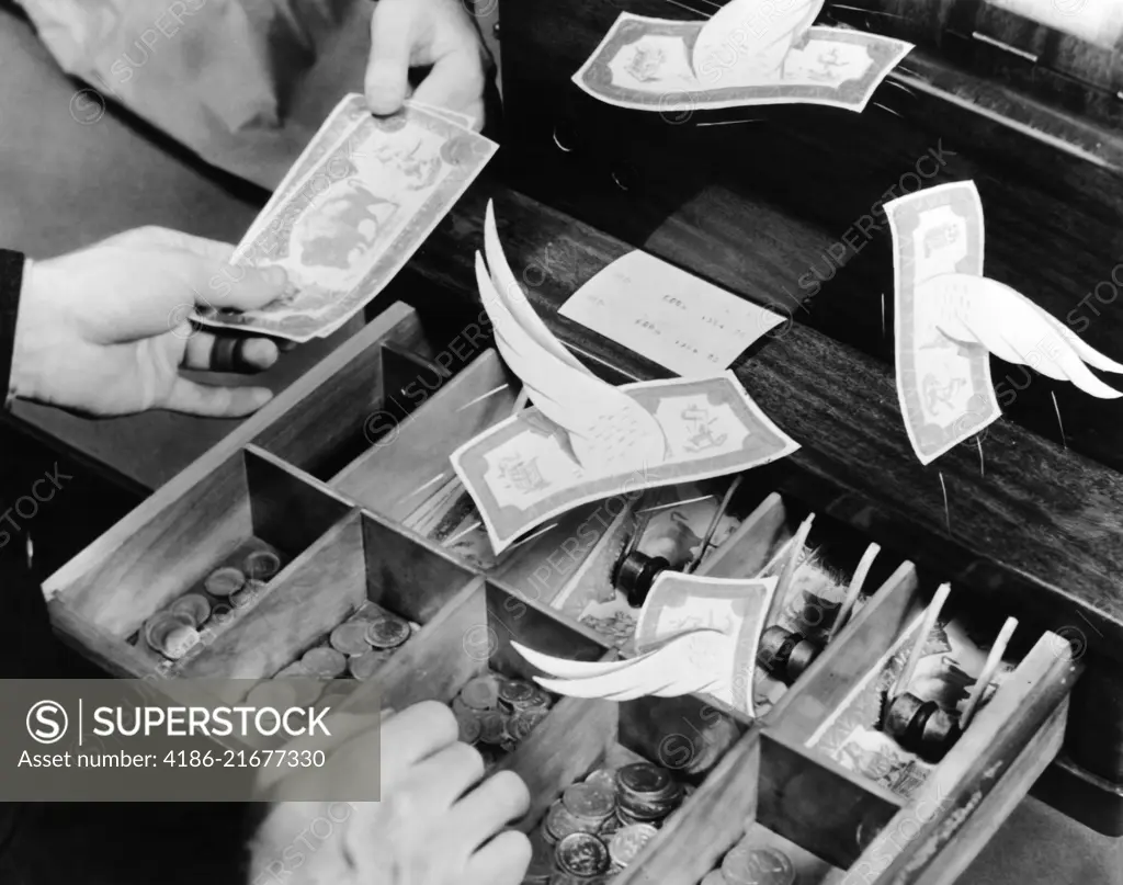 1940s MALE HANDS CASHIER GIVING CHANGE TO CUSTOMER CURRENCY BILLS WITH WINGS FLYING OUT OF THE CASH REGISTER TILL 