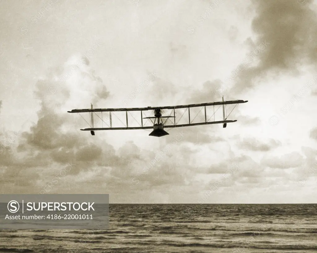 1910s EARLY WALSH BROTHERS WORLD WAR ONE BIPLANE SEAPLANE PILOT TRAINING FLYING BOAT OVER THE OCEAN OUTDOOR NEW ZEALAND