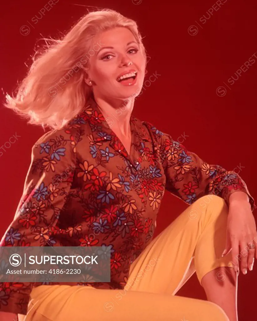 1960S Blond Woman Wind Blown Hair Wearing Yellow Capri Pants - SuperStock