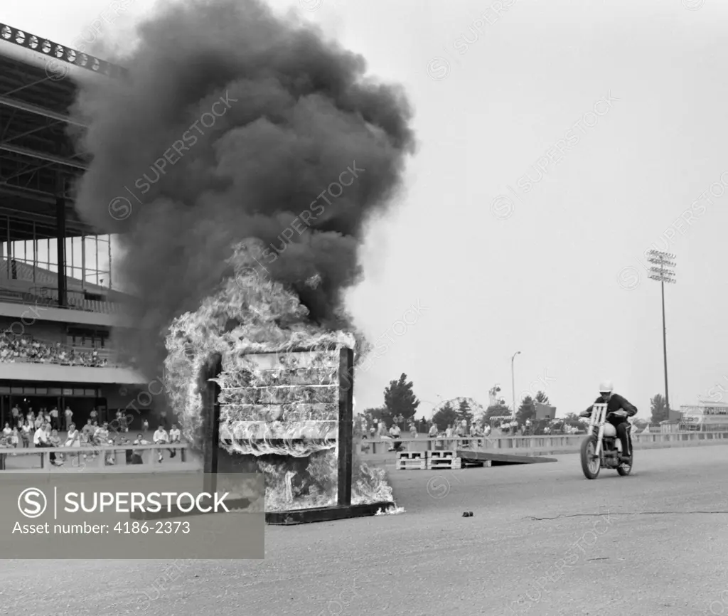 1960S Daredevil On Motorcycle Approaching Wall Of Fire