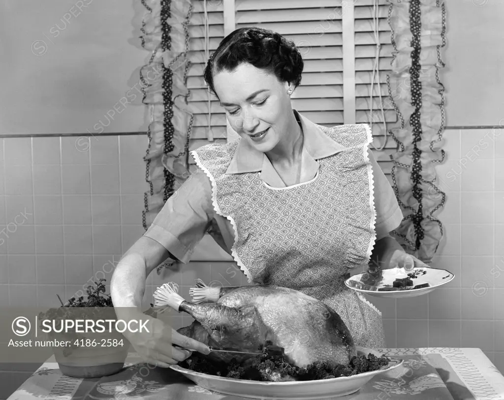 1960S Woman In Apron Dishing Cranberry Sauce Out Around Turkey