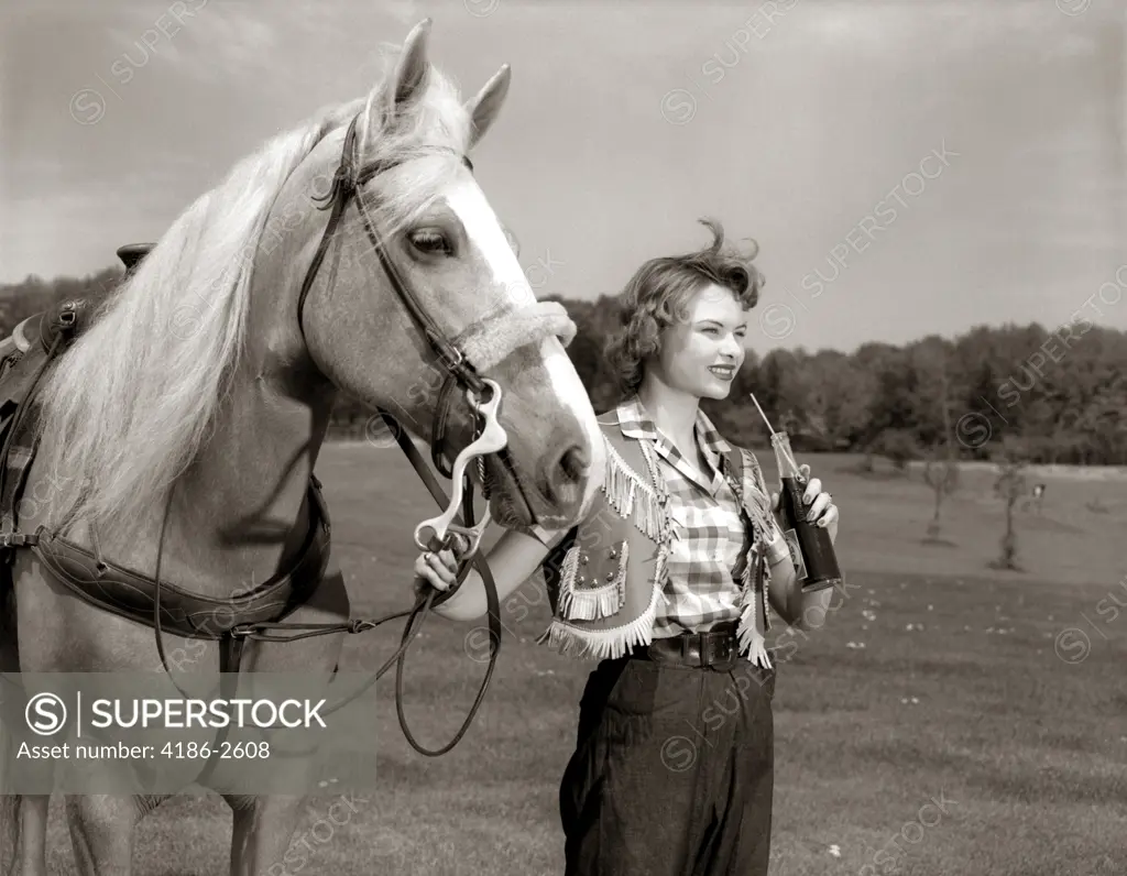 1950S Teenage Girl Western Wear Holding Horse Halter Drinking Carbonated Beverage From Bottle