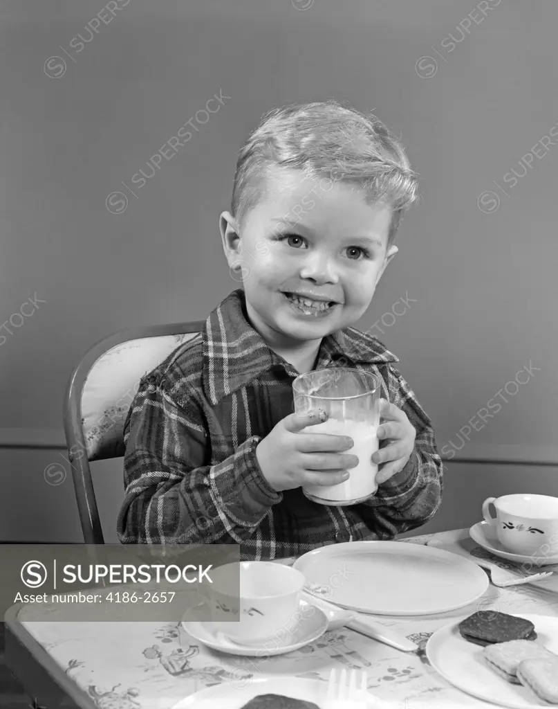 1950S Smiling Boy In Plaid Shirt Drinking Milk At Card Table Happy Nutrition Snack Cookies