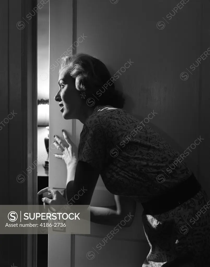 1950S Woman Peeking Through Open Door