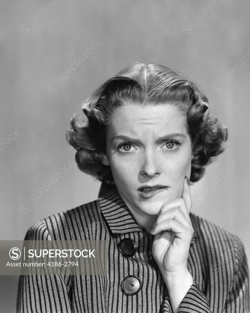 1950S 1960S Woman In Striped Dress With Buttons Hand To Chin Comic Worried Expression Looking At Camera