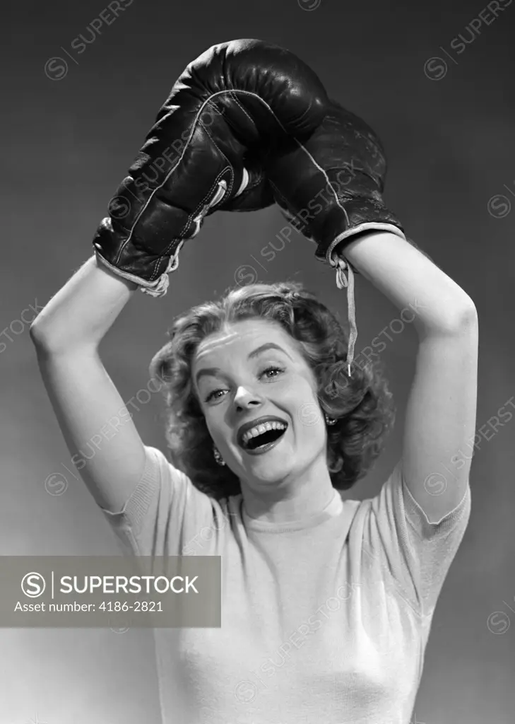 1950S Portrait Of Woman Wearing Boxing Gloves In Winning Pose Raised Overhead