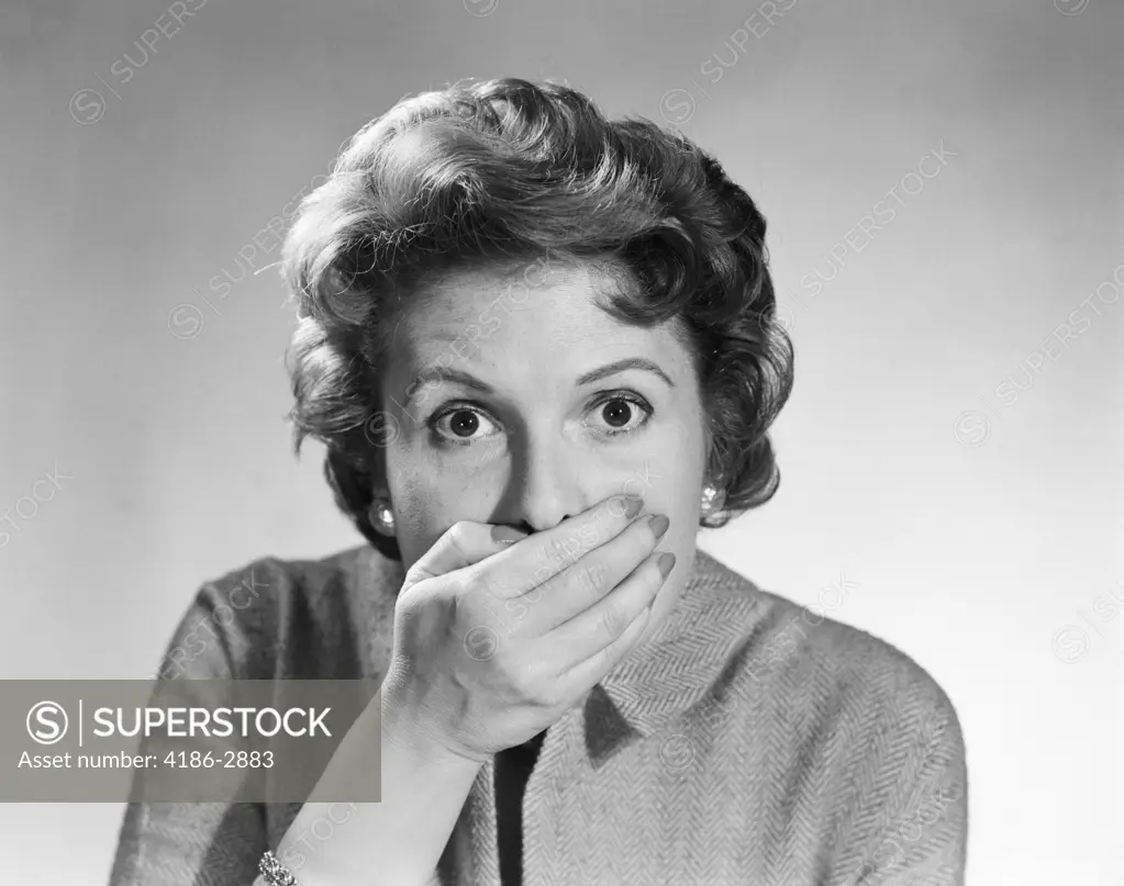 1950S Head Shot Of Startled Woman Covering Mouth With Hand 