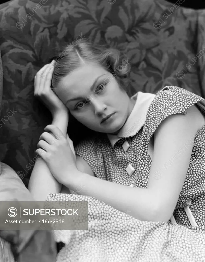 1930S Woman Moping Looking Sad Or Depressed Or With A Headache Leaning Her Head On Her Hand
