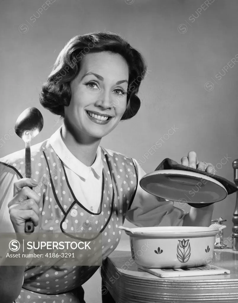 1960S Woman Housewife About To Stir Pot With Spoon Smiling Cooking