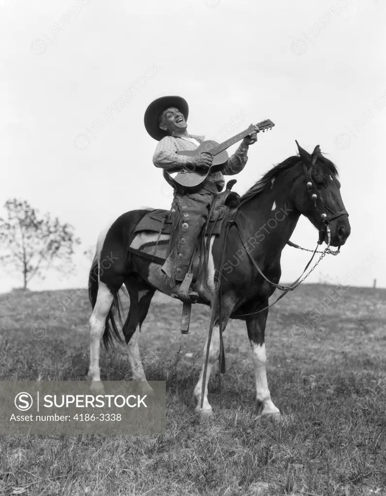 1920S Cowboy On Horse Singing & Playing Guitar