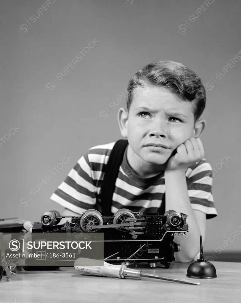 1930S 1940S Little Boy Thinking Or Worrying About Broken Lionel Electric Toy Train Engine Mechanical Ability Problem Solving