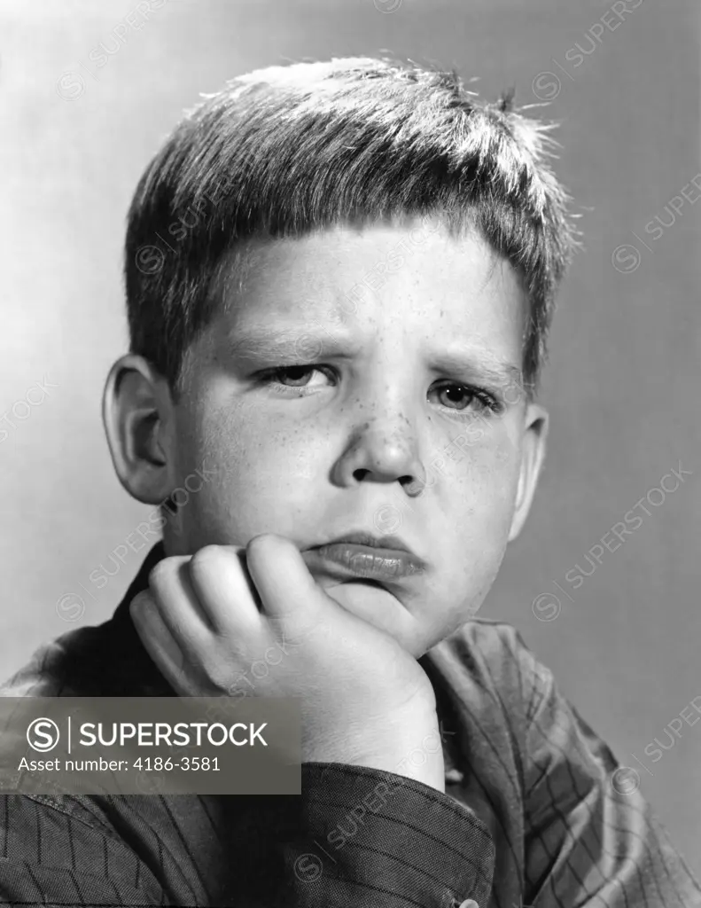 1960S Portrait Pouting Boy Hand To Chin With Angry Sad Serious Facial Expression