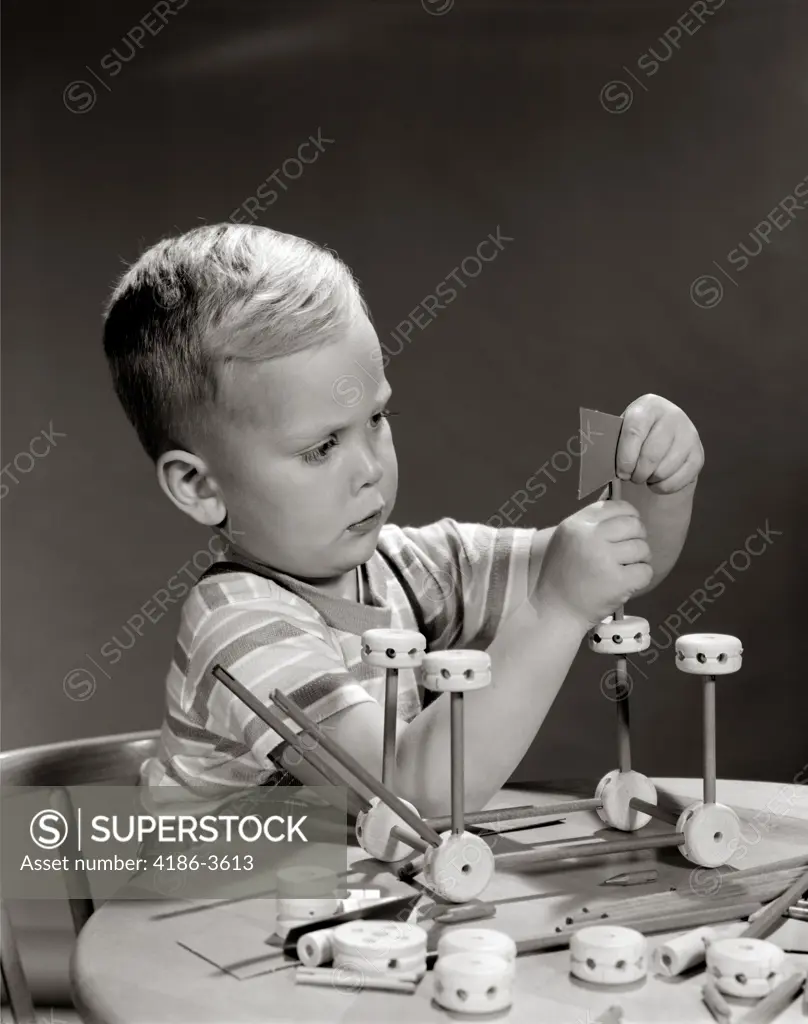 1960S Boy Seated At Table Playing With Tinker Toys